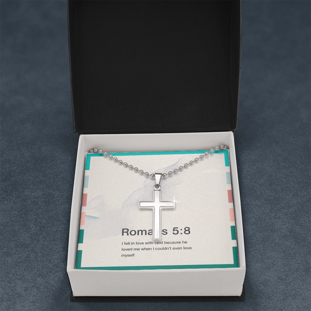 Close-up of minimalist stainless steel cross pendant on ball chain