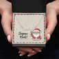 Close-up of Joyeux Noël cursive name necklace on gift card