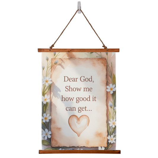 Dear God Show Me How Good It Can Get wall tapestry with wooden frame and floral border hanging on white wall