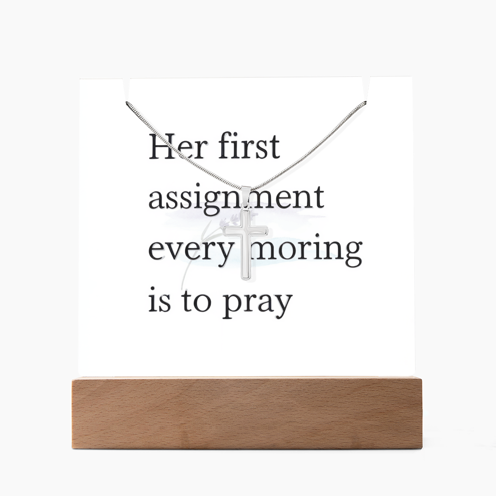 Close-up of polished stainless steel cross on snake chain