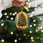 Gift-ready Christmas ornament packaged with ribbon and gold string