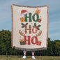 Woven Christmas throw featuring festive Ho Ho Ho design