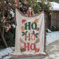 Holiday throw blanket with gifts and holly pattern