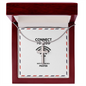 Close-up of stainless steel cross pendant with polished finish