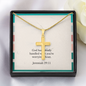 Polished stainless steel cross necklace glowing in natural light