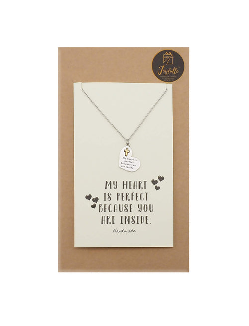 Necklace with a pendant on a card with text, displayed on a brown box.