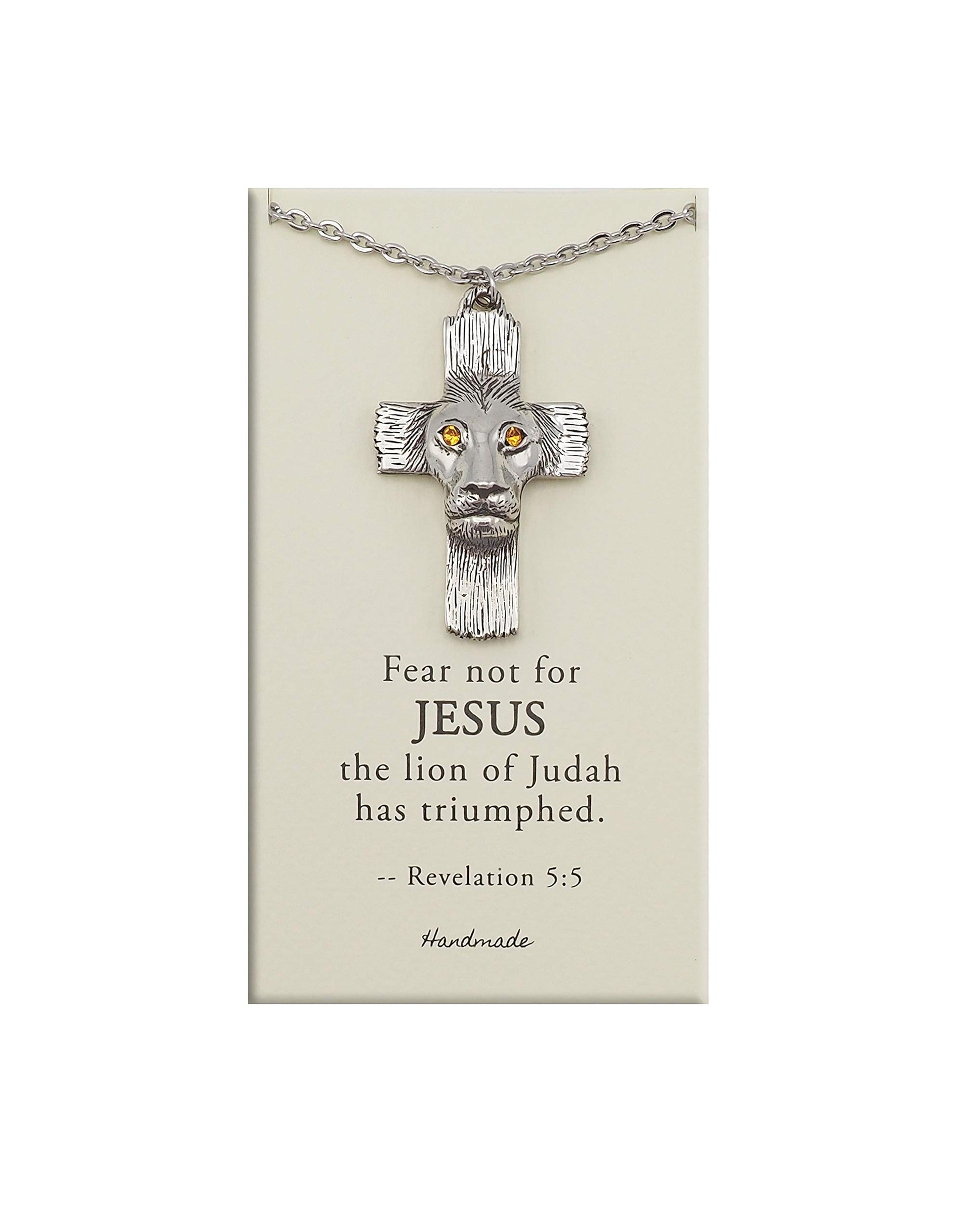 Silver cross necklace with lion head design on a beige card with text, on a white background
