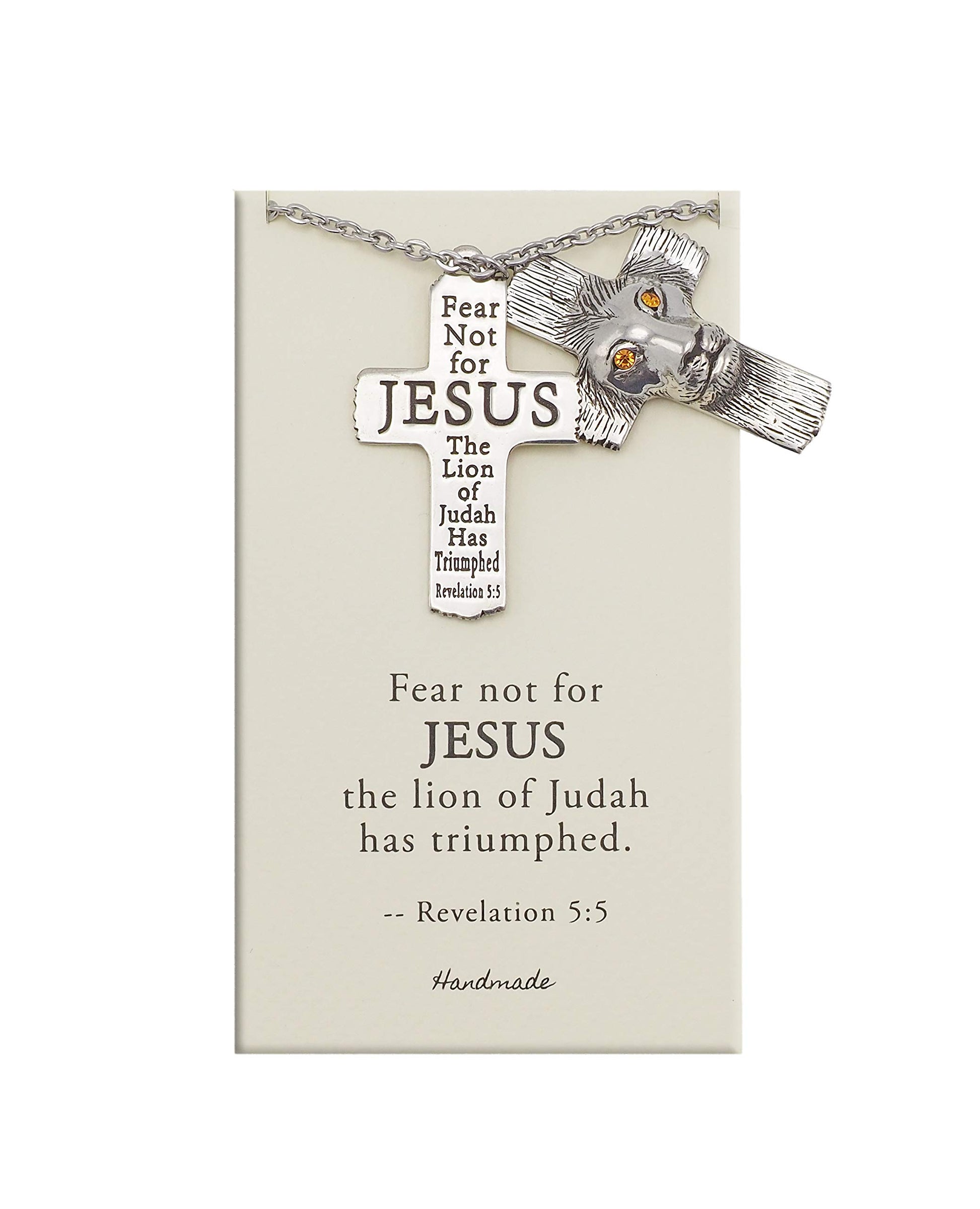 Silver cross necklace with lion charm on a card with religious text