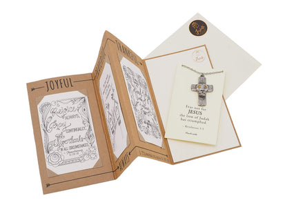 Open card with religious text and illustrations on a white background