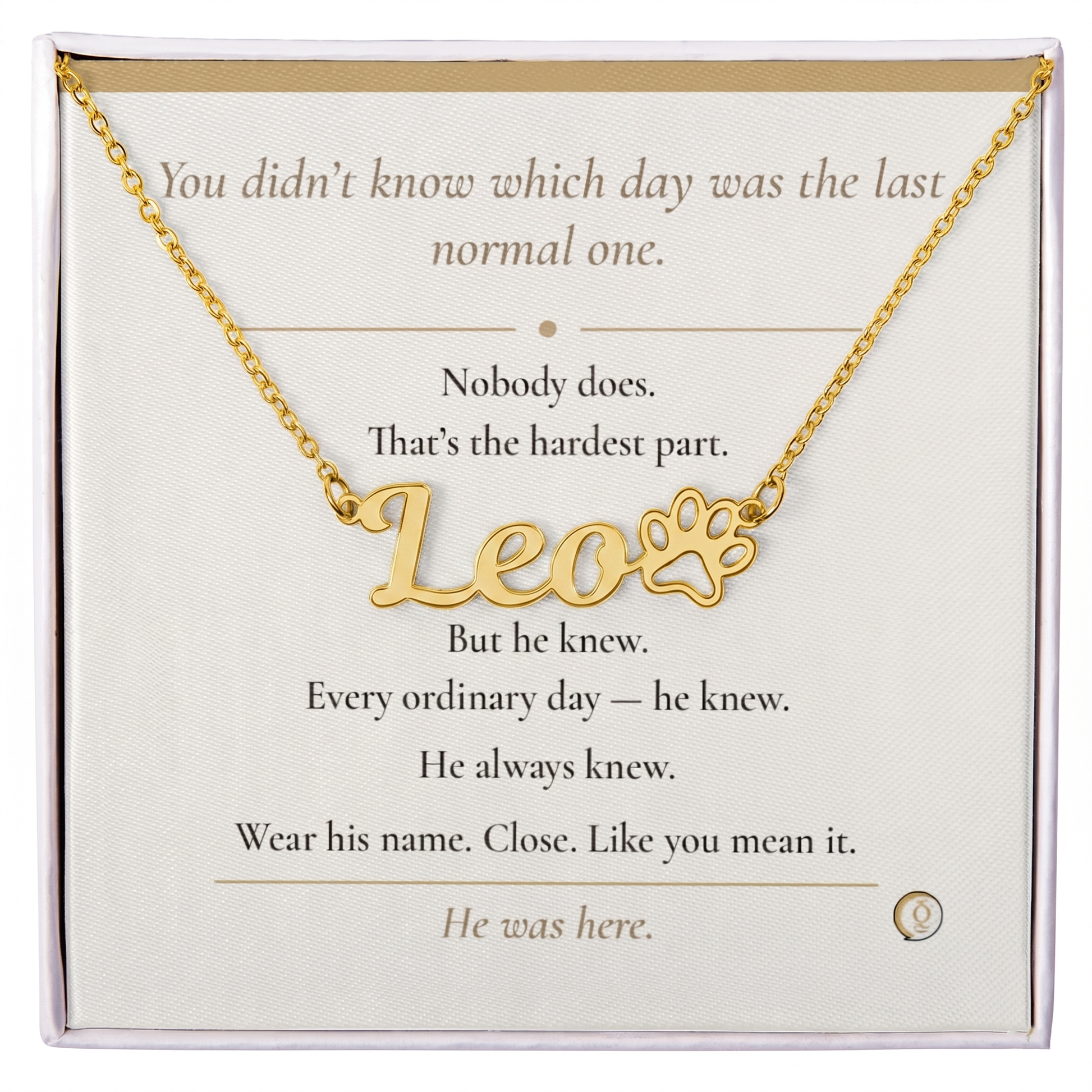 Gold necklace with 'Leo' and paw print design on a message card.