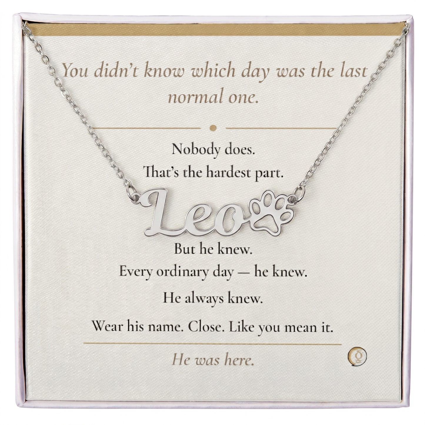 Necklace with paw print and 'Leo' text on a card with inspirational message