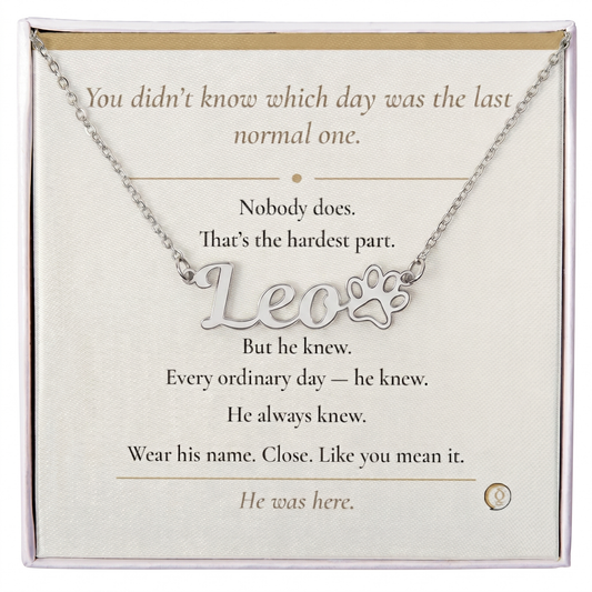 Necklace with paw print and 'Leo' text on a card with inspirational message
