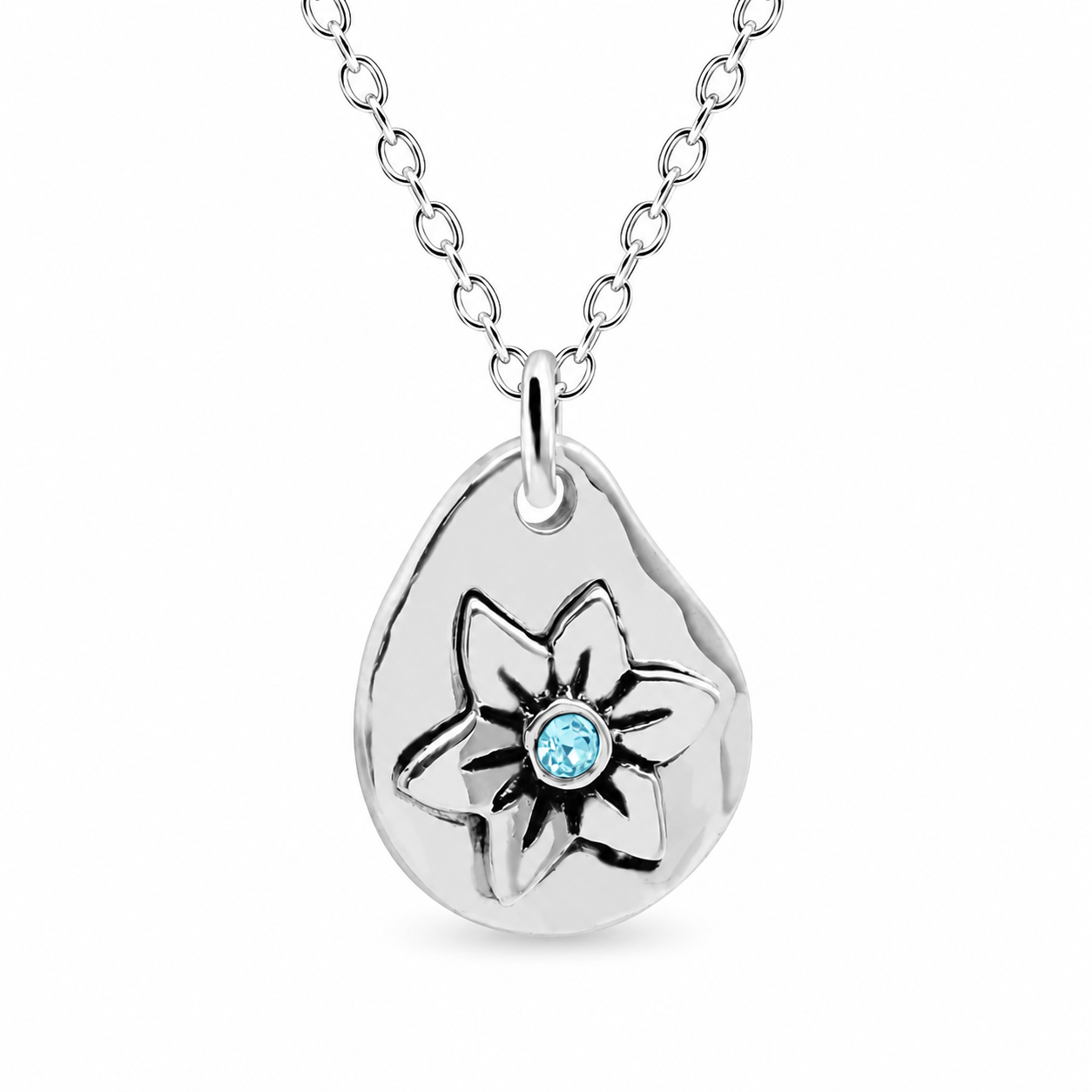 A silver teardrop pendant necklace featuring a stylized flower design with a small round light blue gemstone at the center, shown on a white background.
