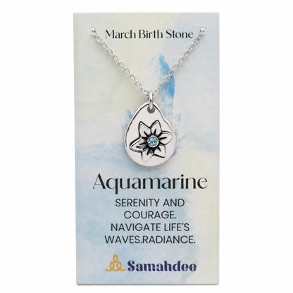 A silver teardrop pendant necklace with a lotus flower design and a small aquamarine stone, displayed on a branded Samahdee card labeled 'March Birth Stone' and 'Aquamarine'.