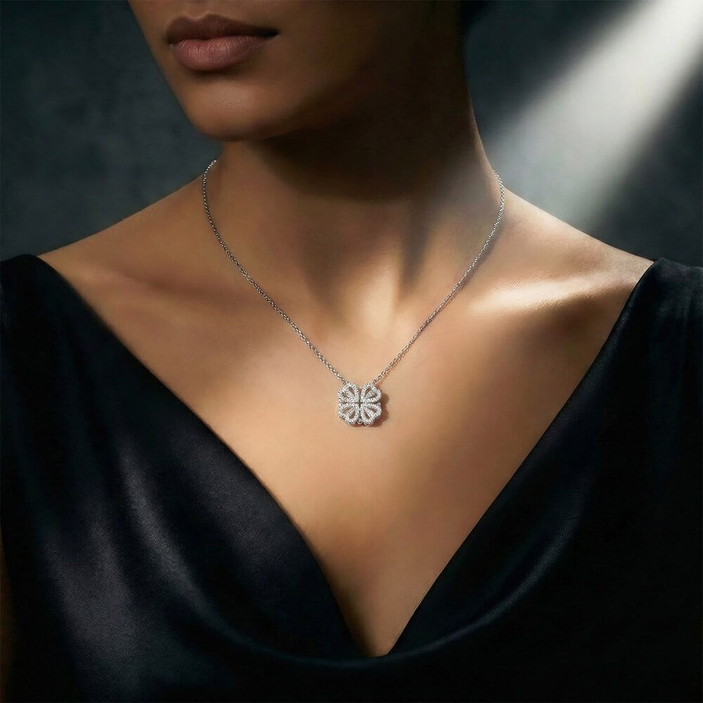 Silver necklace with a floral pendant on a dark background