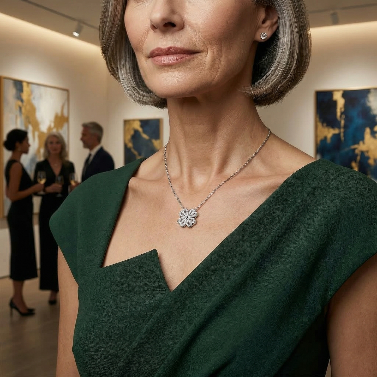 Woman wearing a green dress and silver necklace in an art gallery setting