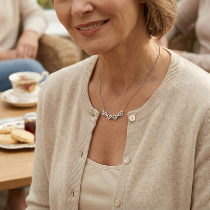 Woman wearing a necklace with a heart design in a casual setting