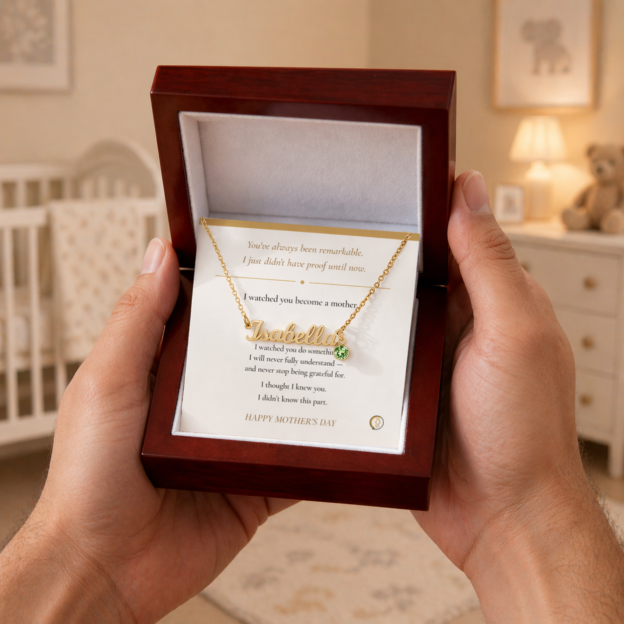 Necklace with a message card held in front of a wooden box in a home setting