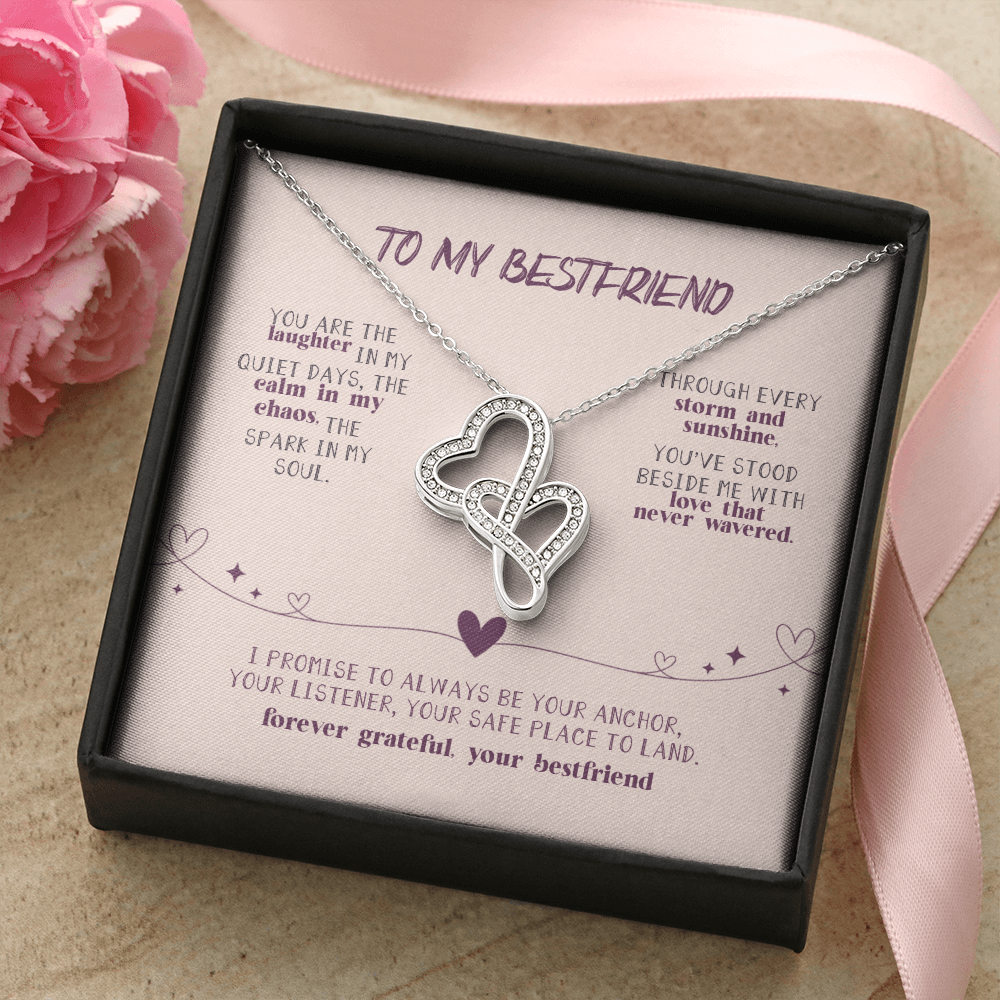 Close-up of 14K white gold interlocking hearts pendant with CZ crystals