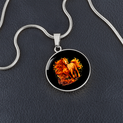 Close-up of fire horse pendant on black background