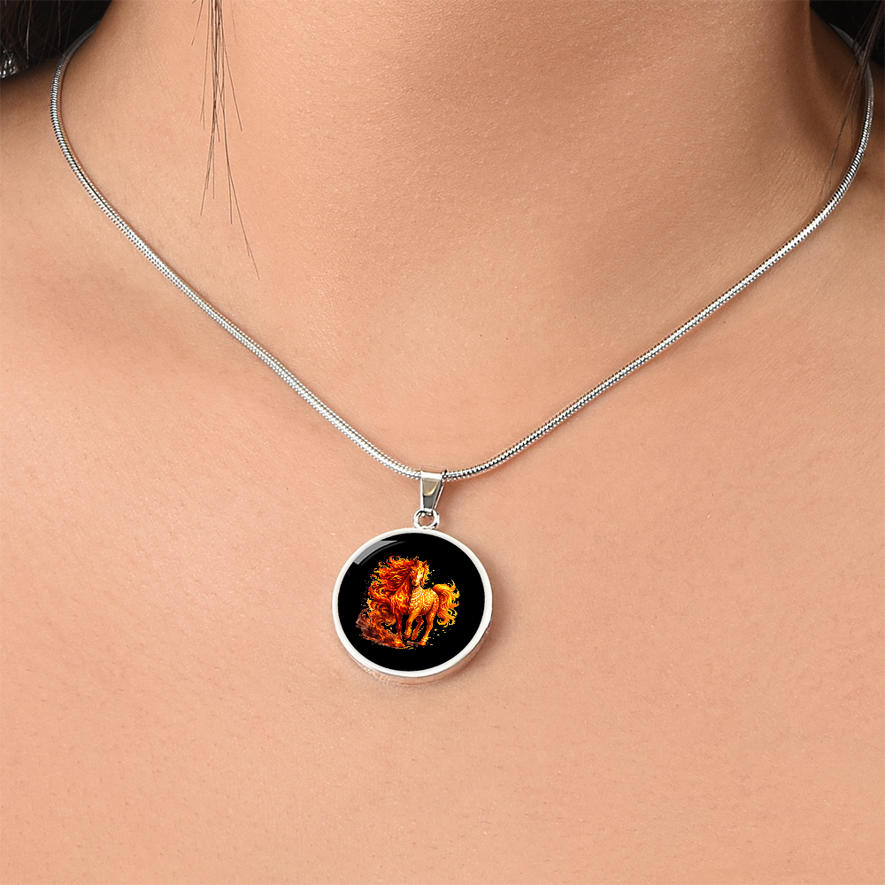 Close-up of fire horse pendant on black background