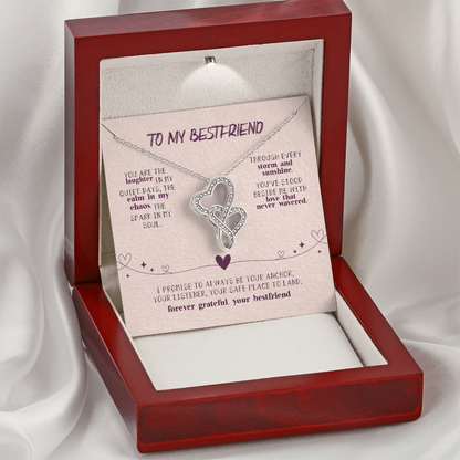 Two interlocking heart pendant on white background