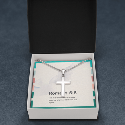 Close-up of minimalist stainless steel cross pendant on ball chain