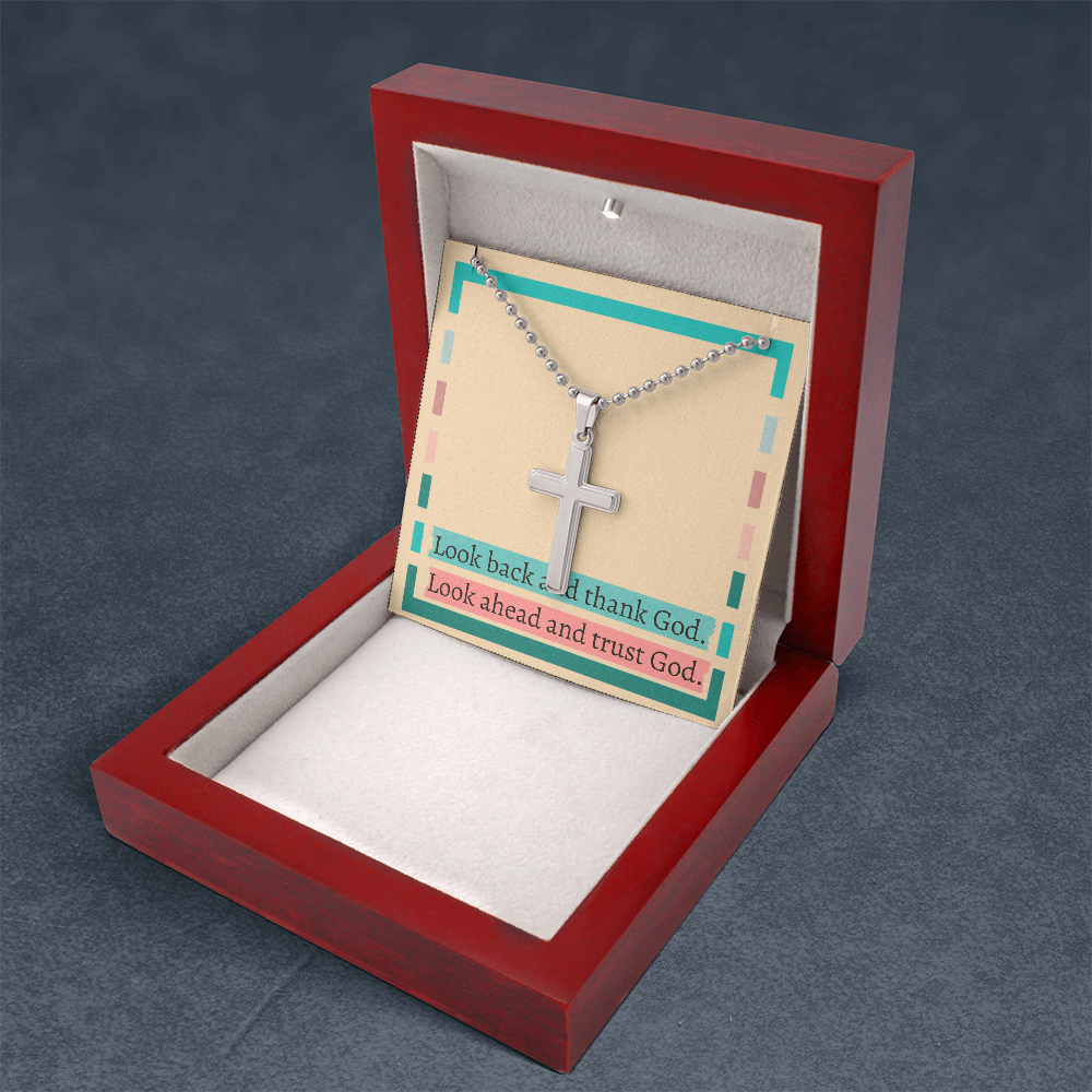 “Look Back and Thank God” cross necklace resting on gift box