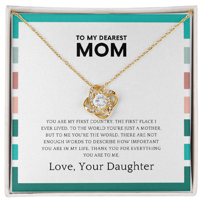 Mother wearing love knot necklace symbolizing daughter’s love