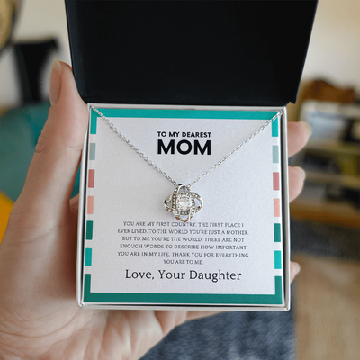 Close up of love knot pendant with cubic zirconia center stone