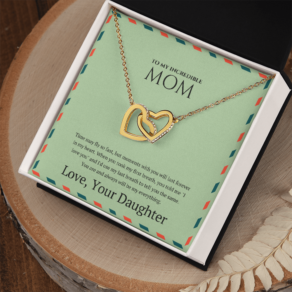 Mother wearing interlocking hearts necklace symbolizing daughter’s love