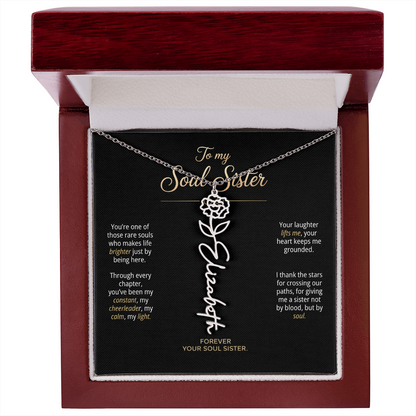 Close-up of birth flower necklace with script name pendant