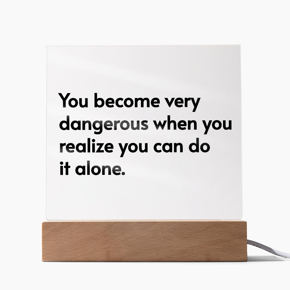 Light up acrylic plaque with inspirational quote glowing in soft LED colors on desk