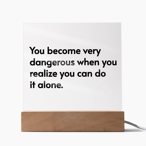 Light up acrylic plaque with inspirational quote glowing in soft LED colors on desk