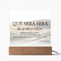 Que Sera Sera acrylic plaque with inspirational quote and wooden LED base on white background