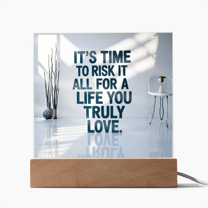 Acrylic plaque with quote “Risk It All for a Life You Truly Love” glowing on LED base.