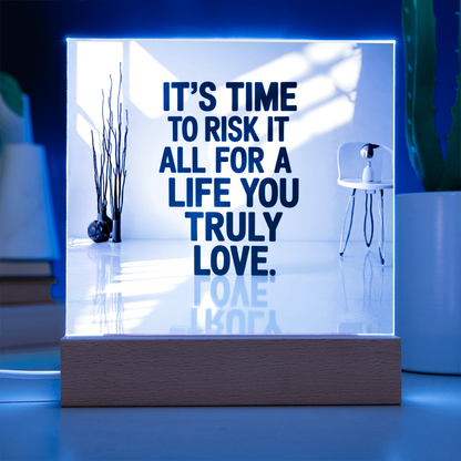 Wooden LED light base glowing with multiple colors illuminating acrylic plaque.