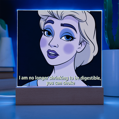 “No Longer Shrinking” quote acrylic plaque glowing softly on LED light base, creating warm ambient lighting.