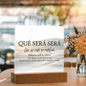Close-up of Que Sera Sera acrylic quote plaque showing text and polished surface