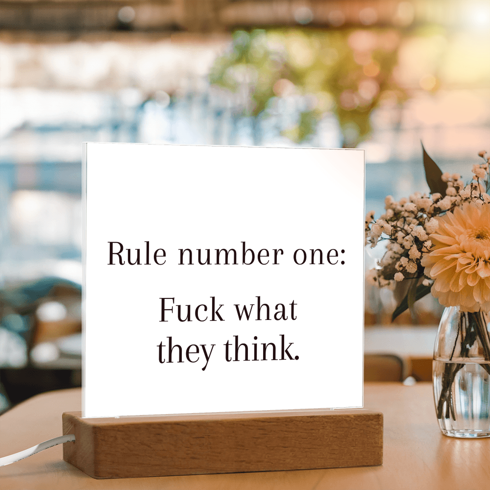 Close-up of bold printed quote on premium acrylic illuminated by LED light.