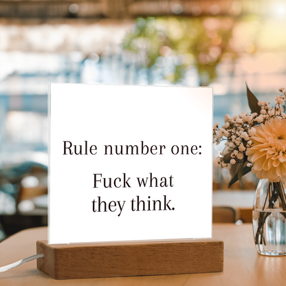 Close-up of bold printed quote on premium acrylic illuminated by LED light.