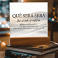 Que Sera Sera acrylic light plaque displayed on desk with soft background lighting