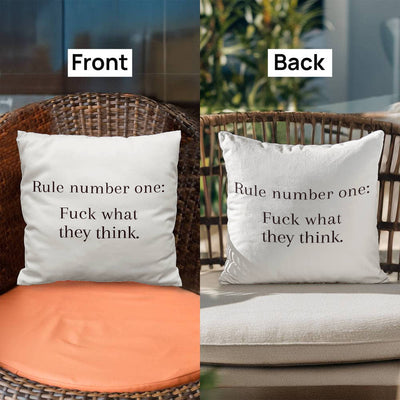 Motivational quote pillow displayed on bed surrounded by neutral bedding and plants.