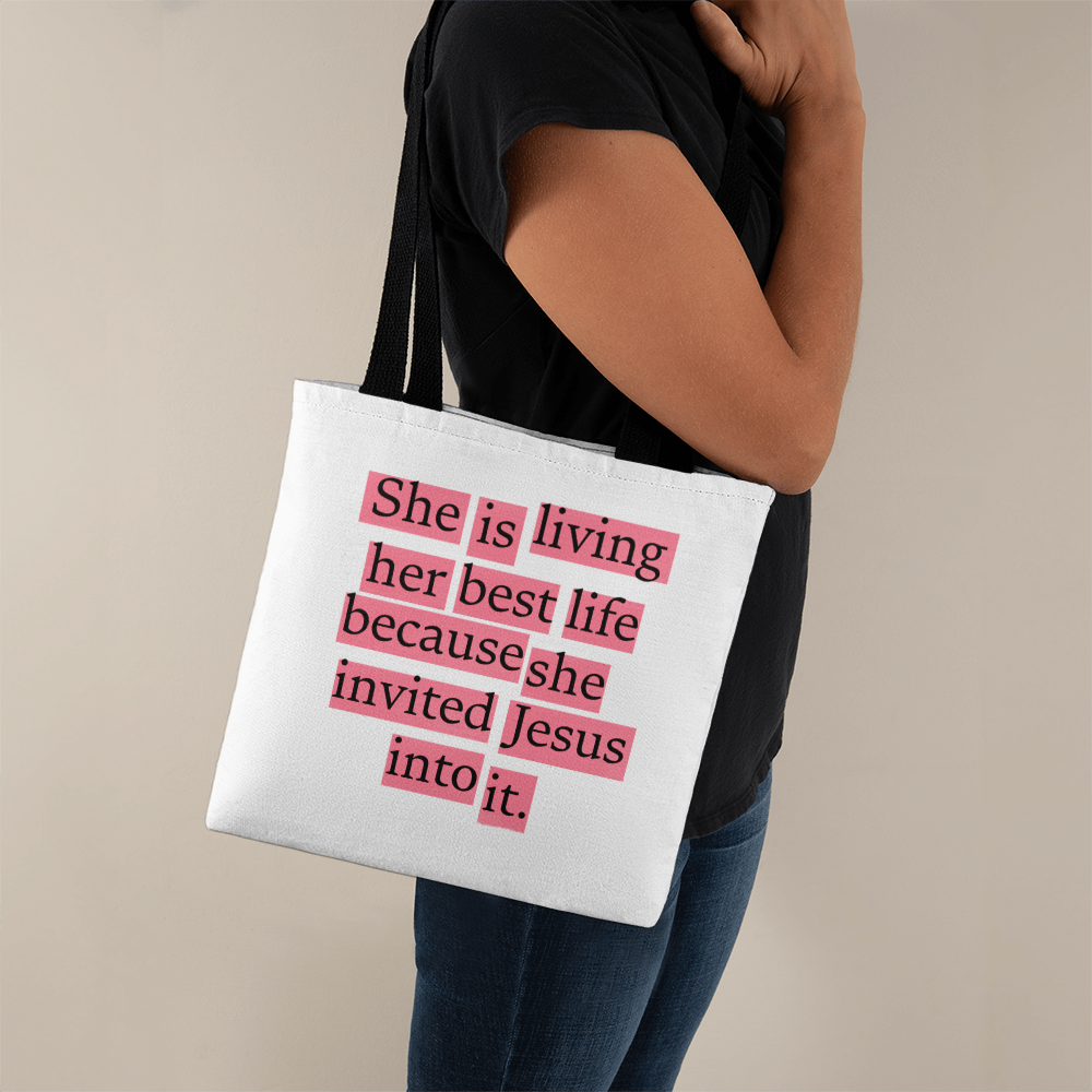 Christian tote bag with quote “She Is Living Her Best Life Because She Invited Jesus Into It.
