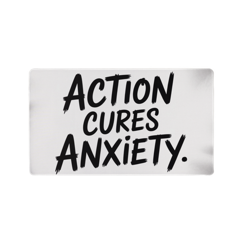“Action Cures Anxiety” motivational gaming mat on modern desk setup