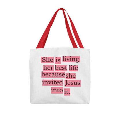 Faith tote bag photographed on neutral surface with journal and flowers.