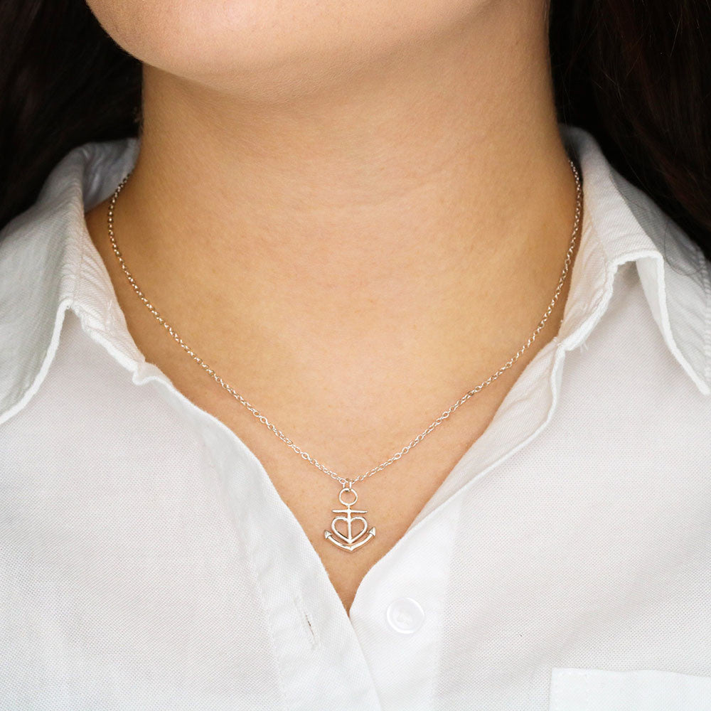 Polished stainless steel anchor pendant close-up