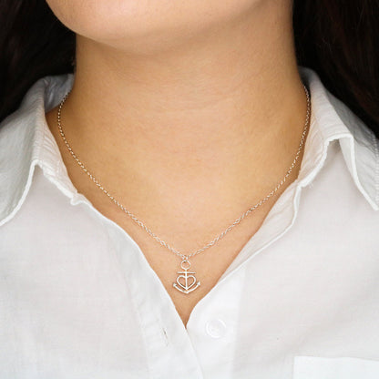 Close-up of polished stainless steel anchor necklace
