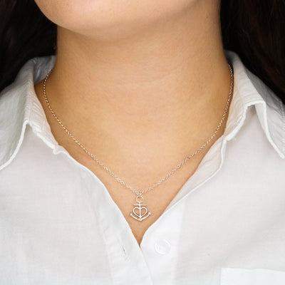 Close-up of polished stainless steel anchor necklace