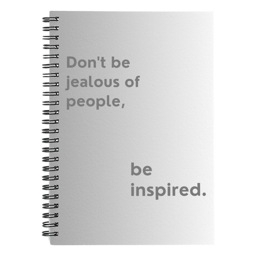 Motivational spiral notebook with quote “Don’t Be Jealous of People, Be Inspired” on printed cover.